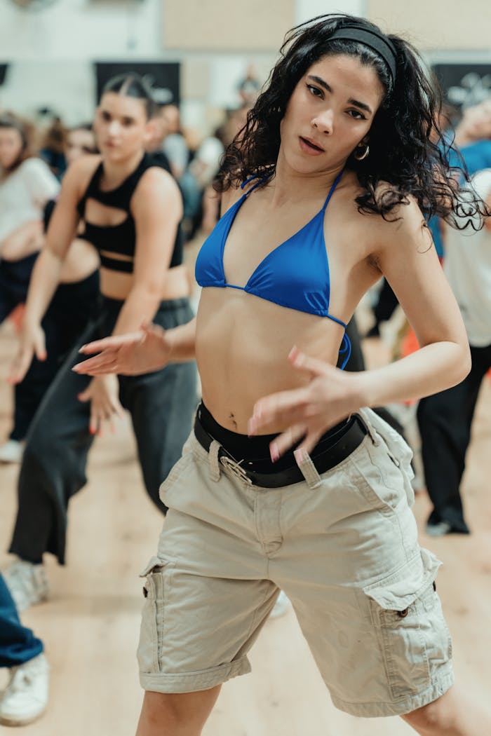 A vibrant dance class with adults expressing themselves in various dance styles.