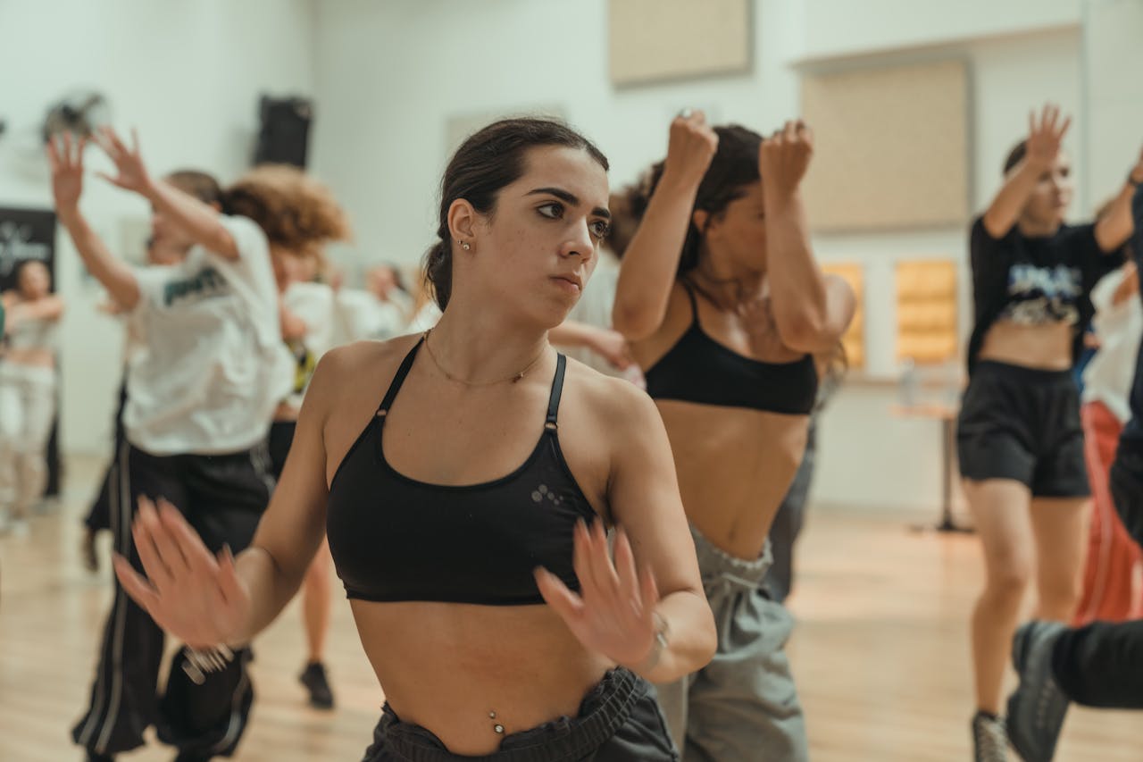 Energetic dancers in a studio, showcasing their skills and focus during a dance workshop.