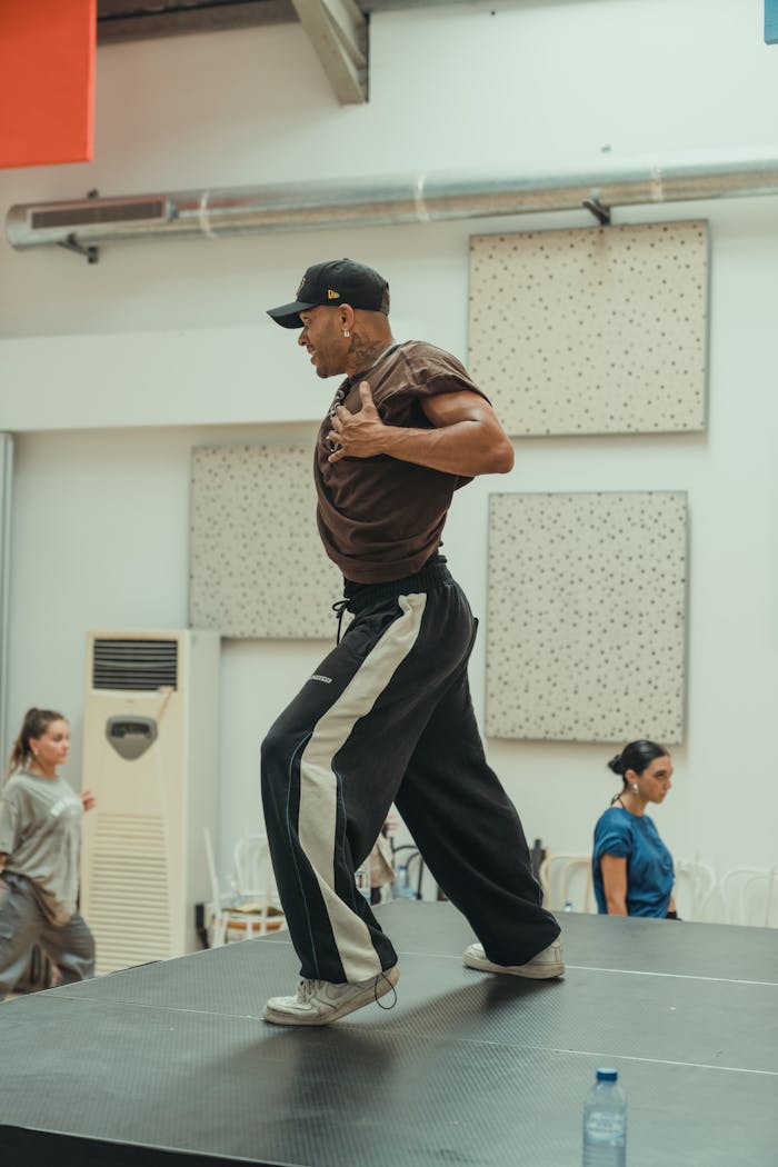 Energetic dance rehearsal with diverse dancers in a modern studio setting.